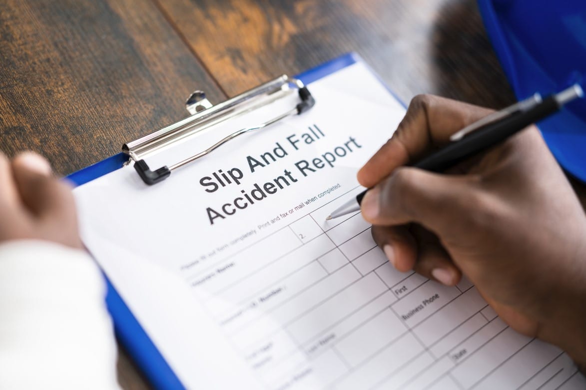 person filling out slip and fall accident report
