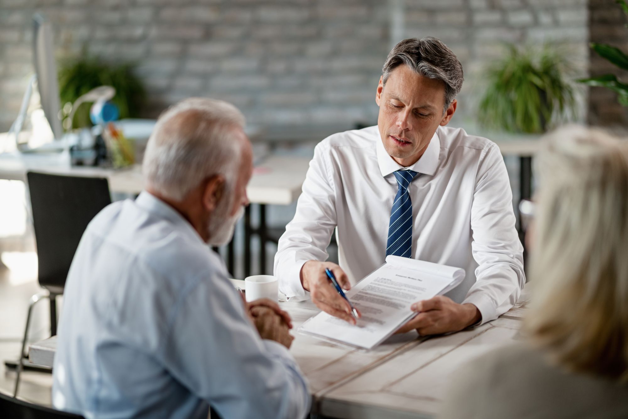 three individuals discussing personal injury case