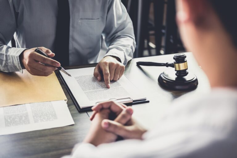 two individuals discussing legal document