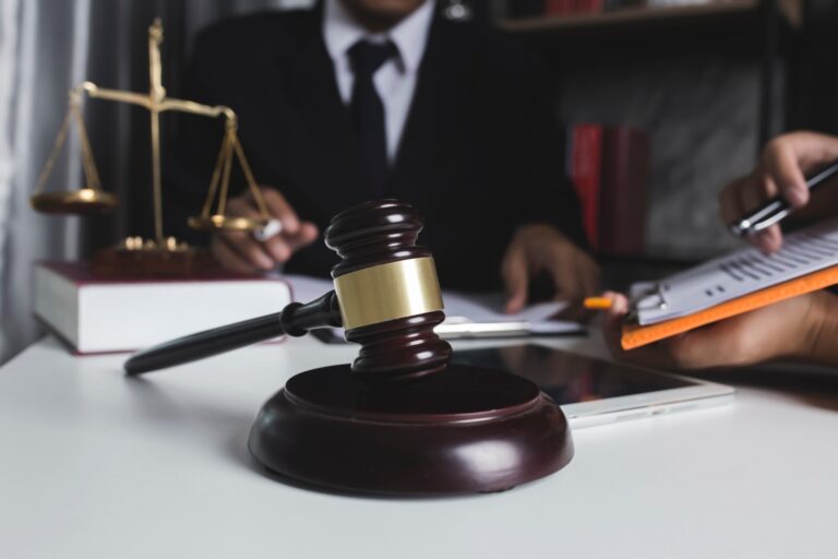 gavel with scales of justice in the background