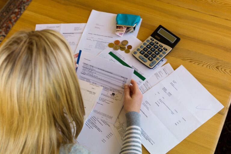 individual looking at bills and expenses