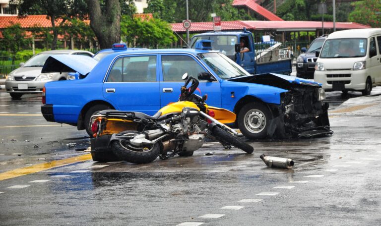 aftermath of a collision between a passenger vehicle and a motorcycle