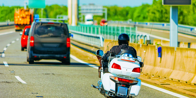 person riding motorcycle on road